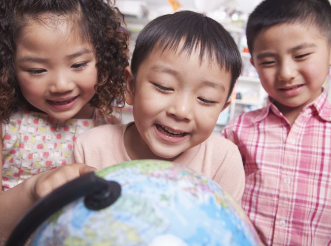 close-up-of-students-looking-at-a-globe-2024-10-14-11-44-05-utc